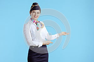 smiling modern female air hostess on blue welcoming