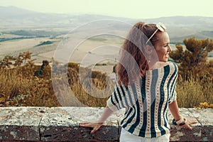 Smiling modern tourist woman looking into distance