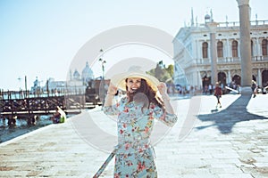 Smiling modern woman in floral dress exploring attractions