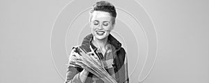 Smiling modern woman grower observing wheat spikelets