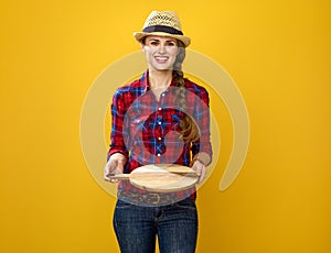 Smiling modern woman grower showing an empty trey