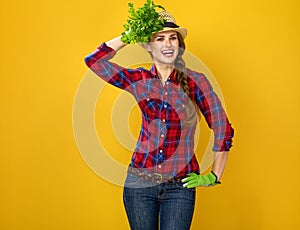 Smiling modern woman grower using fresh parsley as an accessory