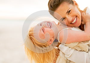 Smiling mother and baby girl having fun time