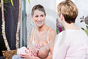 Smiling mother breast feeding her baby