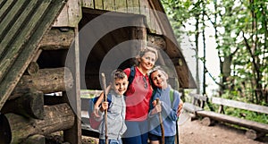 Smiling mother and children going for a hike together