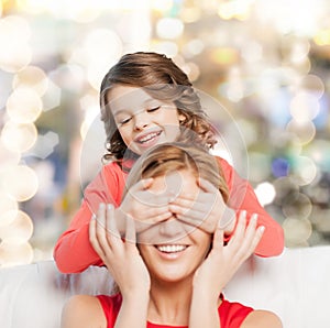 Smiling mother and daughter making a joke