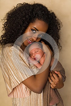 Smiling Mother in gold dress with newborn baby