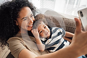 Smiling mother with her baby boy taking a selfie