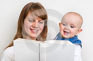 Smiling mother and her child reading a book