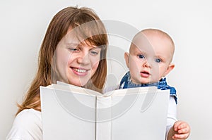 Smiling mother and her child reading a book