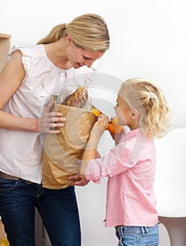 Smiling mother and her Little girl unpacking