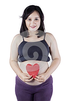 Smiling mother holding heart symbol