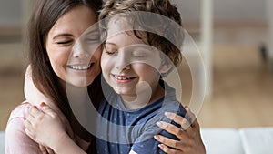 Smiling mother and little son touching cheeks, enjoying tender moment