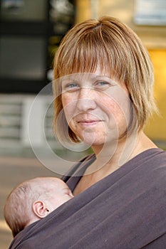 Smiling Mother and Slepping Baby