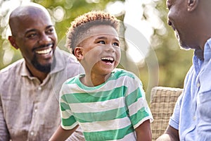 Smiling Multi-Generation Male Family At Home In Garden Together