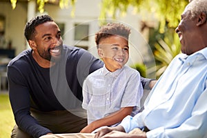 Smiling Multi-Generation Male Family At Home In Garden Together