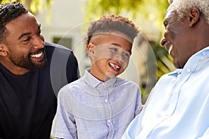 Smiling Multi-Generation Male Family At Home In Garden Together