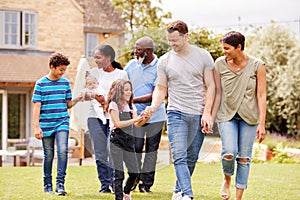 Smiling Multi-Generation Mixed Race Family In Garden At Home Together photo