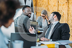 smiling multicultural businessmen talking