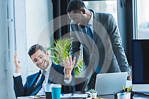 smiling multicultural businessmen talking