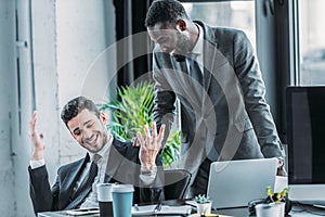 smiling multicultural businessmen talking