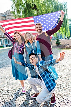 smiling multicultural students with american flag