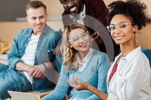 Multicultural students with laptop in lecture hall
