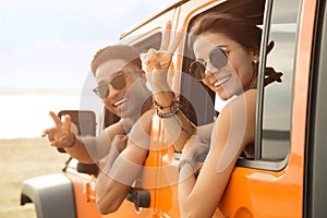 Smiling multiethnic couple sitting in a car