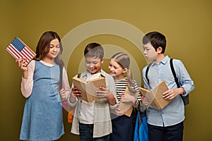 Smiling multiethnic kids with backpacks looking