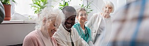 Smiling multiethnic pensioners and nurse in