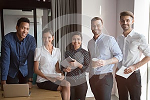 Smiling multiethnic team stand making group picture together