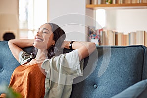 Smiling multiethnic woman relaxing at home with copy space