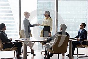 Smiling multiracial business people at meeting shaking hands