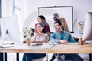 smiling multiracial business team working on project together