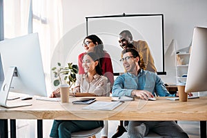 smiling multiracial business team working on project together