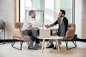 Multiracial businessmen handshake getting acquainted at meeting photo