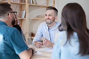 Smiling multiracial colleagues have meeting in office