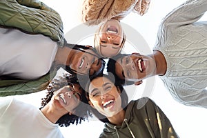 Smiling multiracial friends forming circle of heads