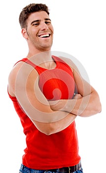 Smiling muscular man posing with crossed arms