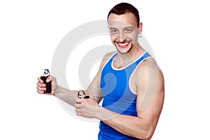 Smiling muscular sportsman with expanders