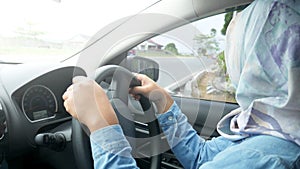 Smiling Muslim Lady Driving a Car