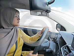 Smiling Muslim Lady Driving a Car