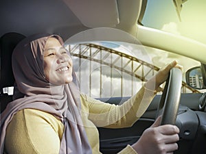 Smiling Muslim Lady Driving a Car