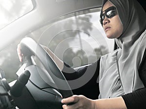 Smiling Muslim Lady Driving a Car