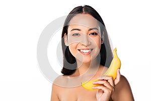 Smiling naked asian woman with banana isolated on white