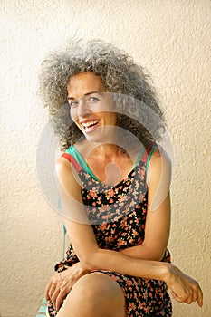 Smiling natural woman over 50 in summer dress