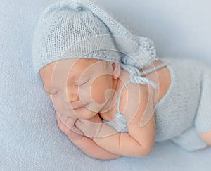 Smiling newborn baby boy sleeping peacefully.