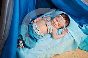 Smiling Newborn Baby Girl Wearing a Belly Dance Costume