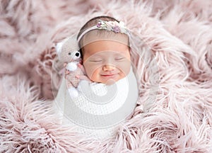 Smiling newborn in diadem