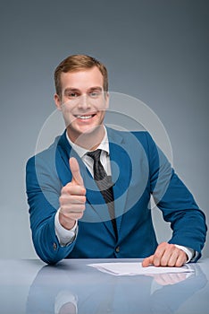 Smiling newscaster showing thumbs up